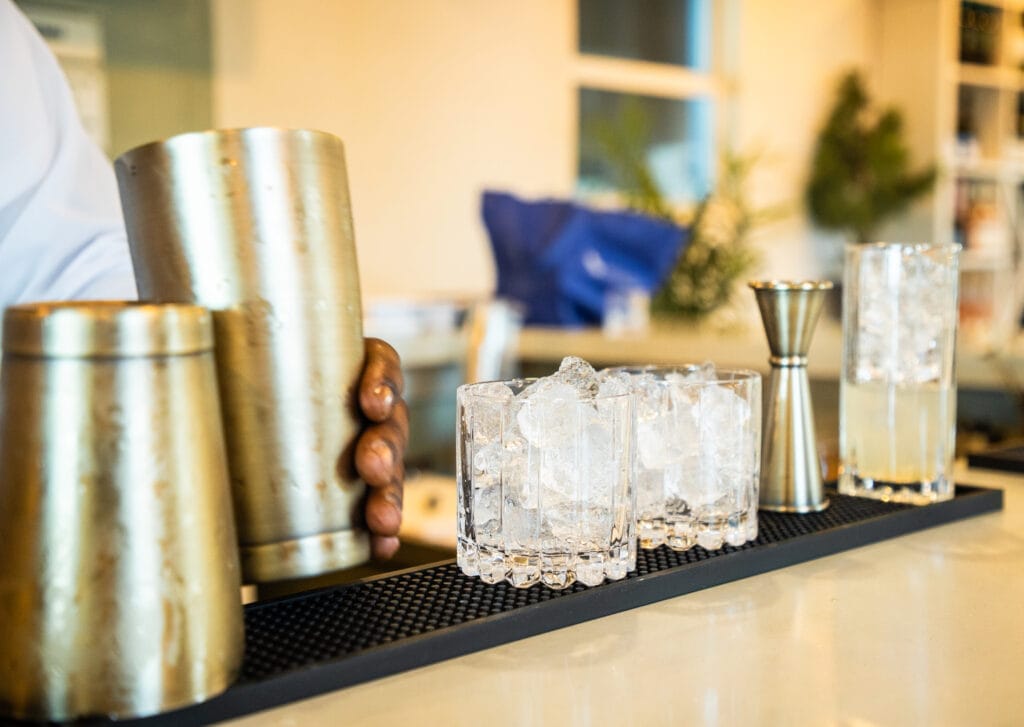 Cocktail shakers, jiggers and glasses of ice lined up on the bar at B’Booky & B’Rabby’s, George Town, Exuma